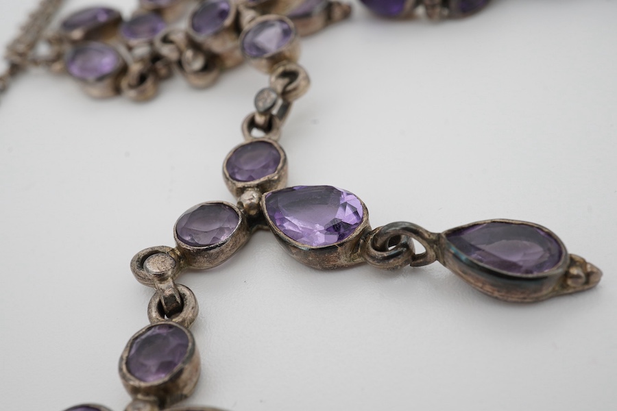 A 925 and amethyst cluster set drop necklace, 44cm, together with a 925 and amethyst set bracelet, a pair of amethyst earrings and a gem set ring. Condition - poor to fair